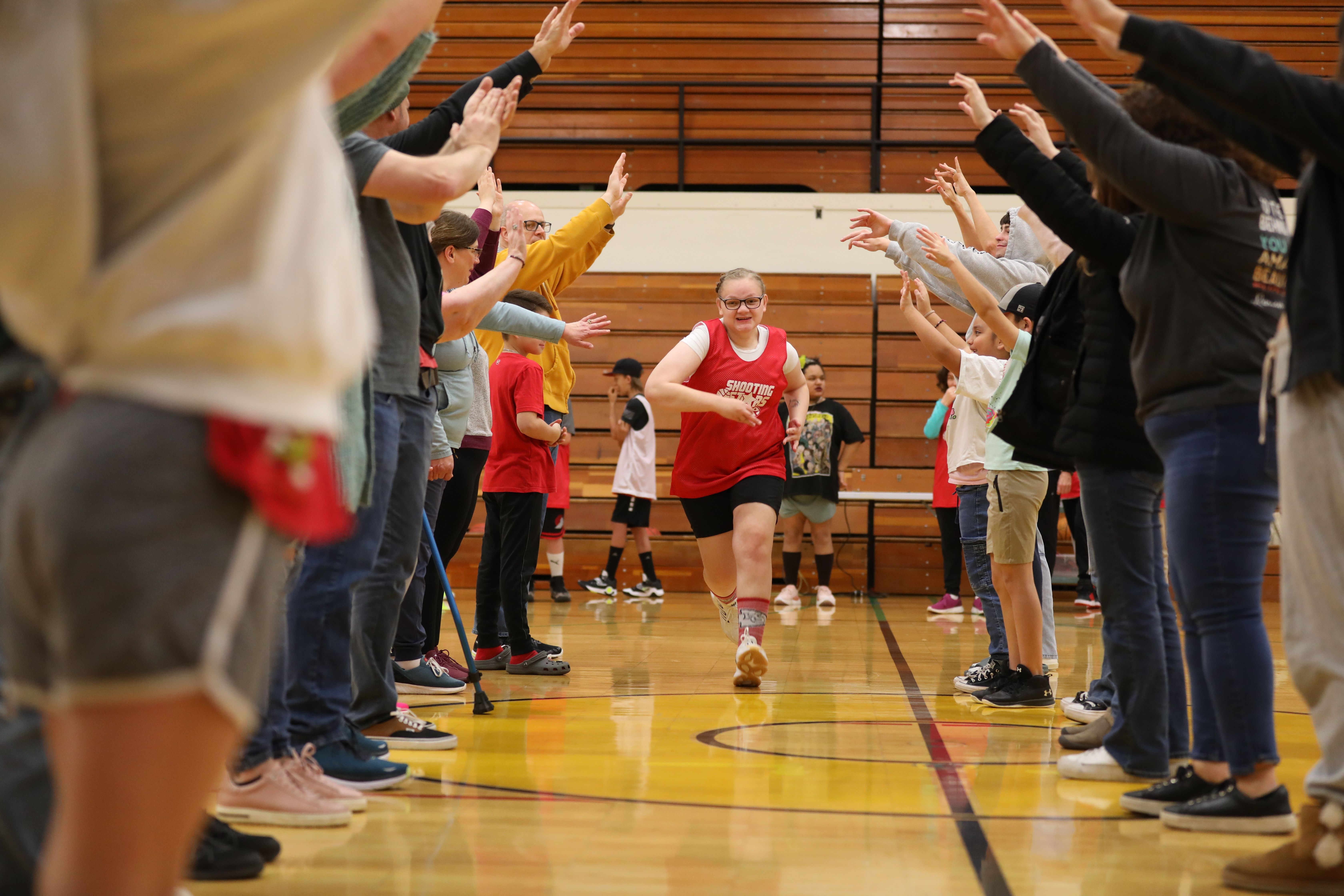 child giving high fives at adaptive and inclusive basketball game