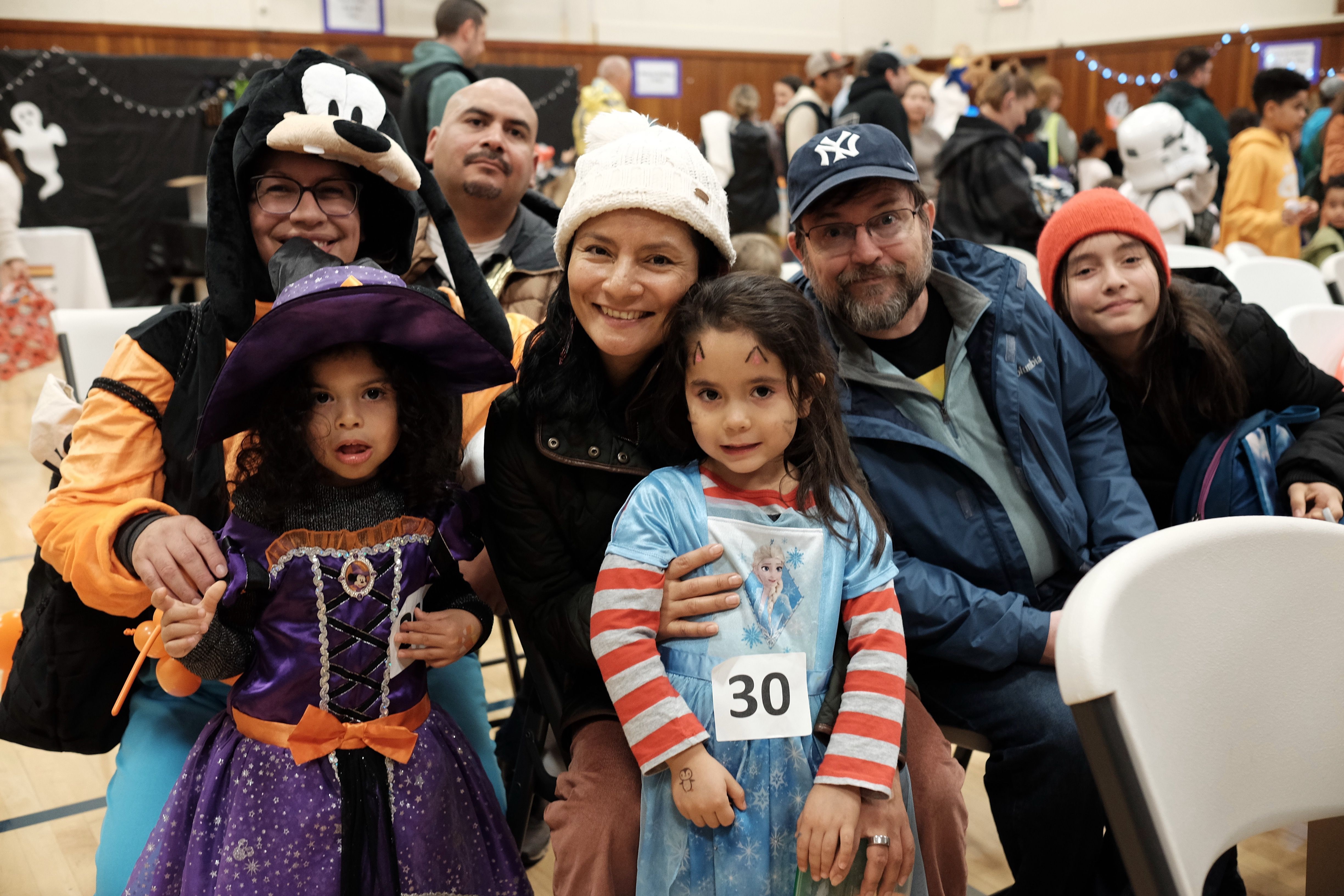 Family wearing halloween costumes