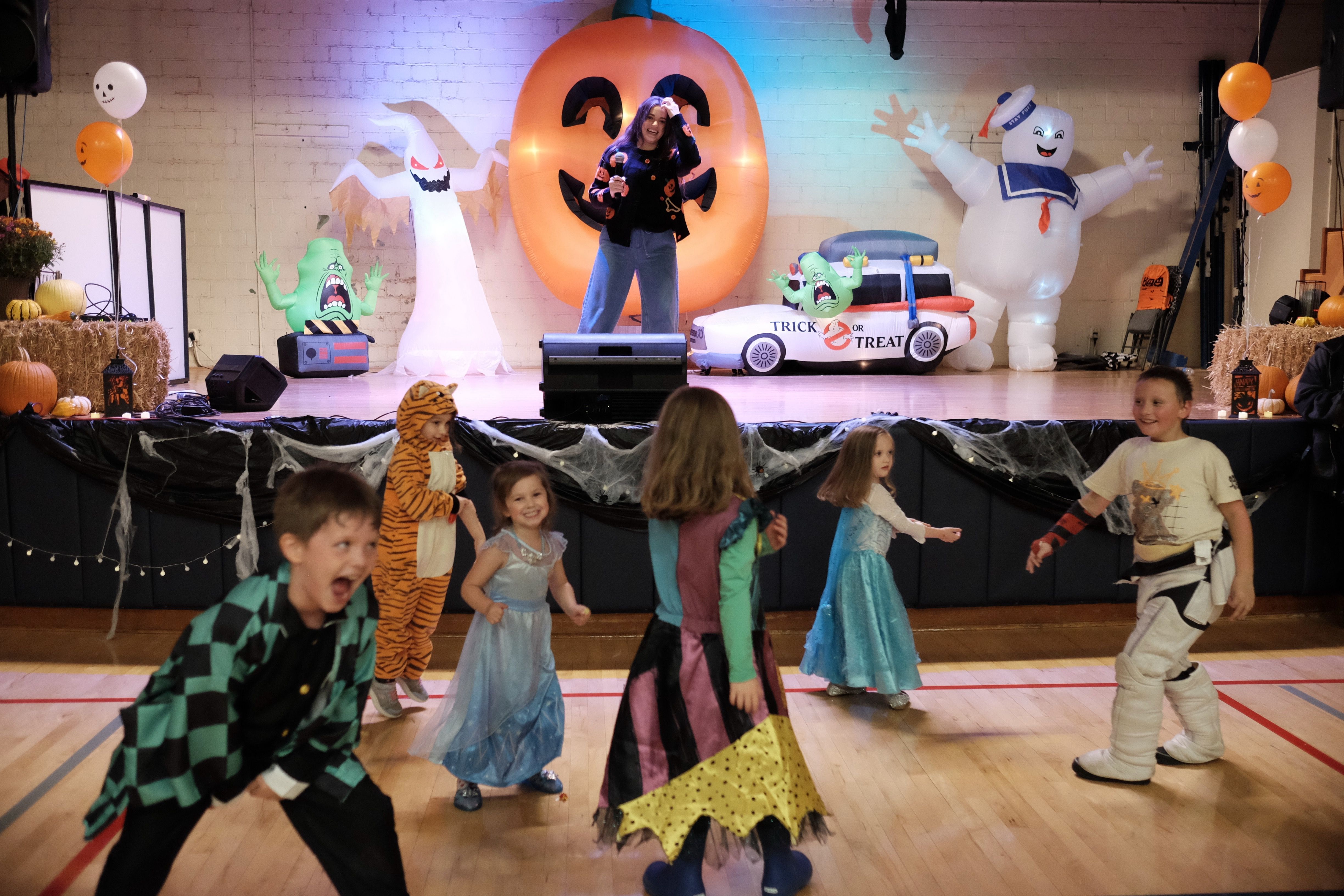 Kids dancing in front of stage at Halloween event