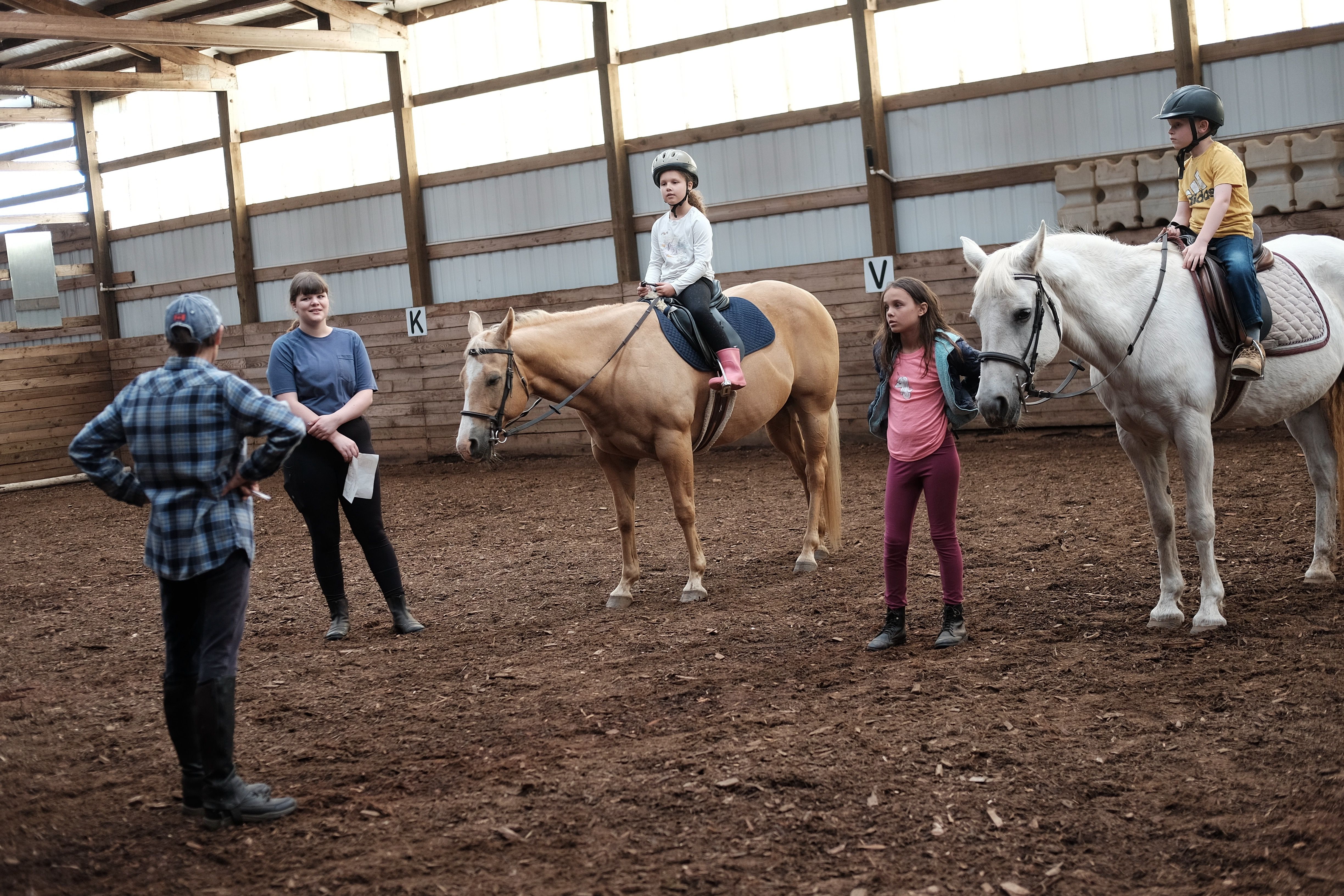 Children on horses for riding class