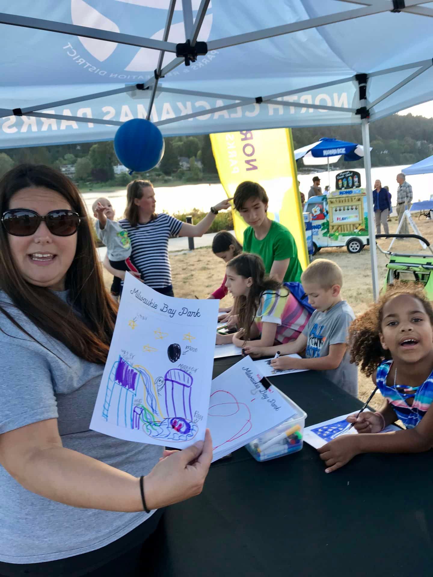 Staff and children at coloring station