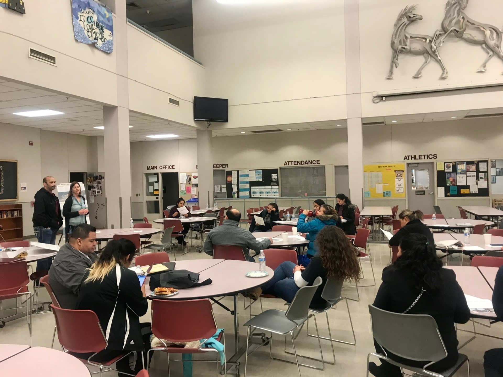 people sitting at  table for public engagement event